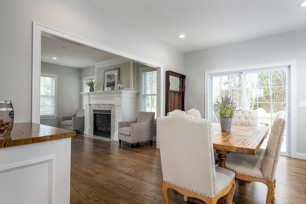 222 Sugar Road Bolton, MA 01740 - Photo 8 of 36 a living room with furniture a fireplace and a table