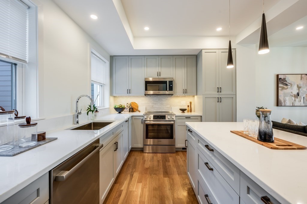 96 Otis Street, Unit 2 Cambridge, MA 02141 - Photo 11 of 42 a kitchen with a sink stove and refrigerator