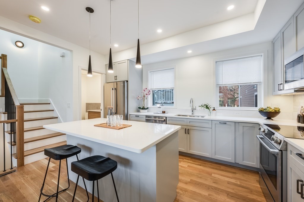 96 Otis Street, Unit 2 Cambridge, MA 02141 - Photo 12 of 42 a kitchen with appliances cabinets and furniture