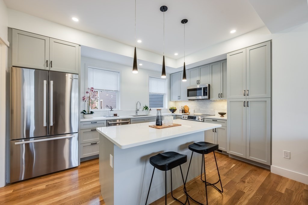 96 Otis Street, Unit 2 Cambridge, MA 02141 - Photo 13 of 42 a kitchen with stainless steel appliances a refrigerator a stove a sink and a refrigerator
