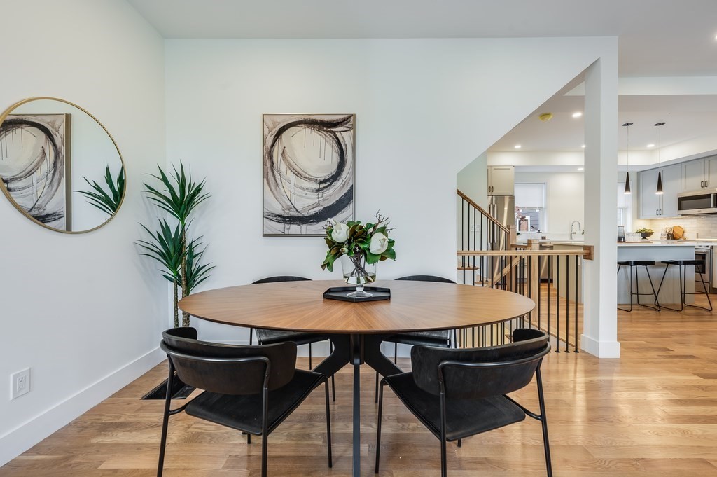 96 Otis Street, Unit 2 Cambridge, MA 02141 - Photo 16 of 42 a dining room with furniture and wooden floor