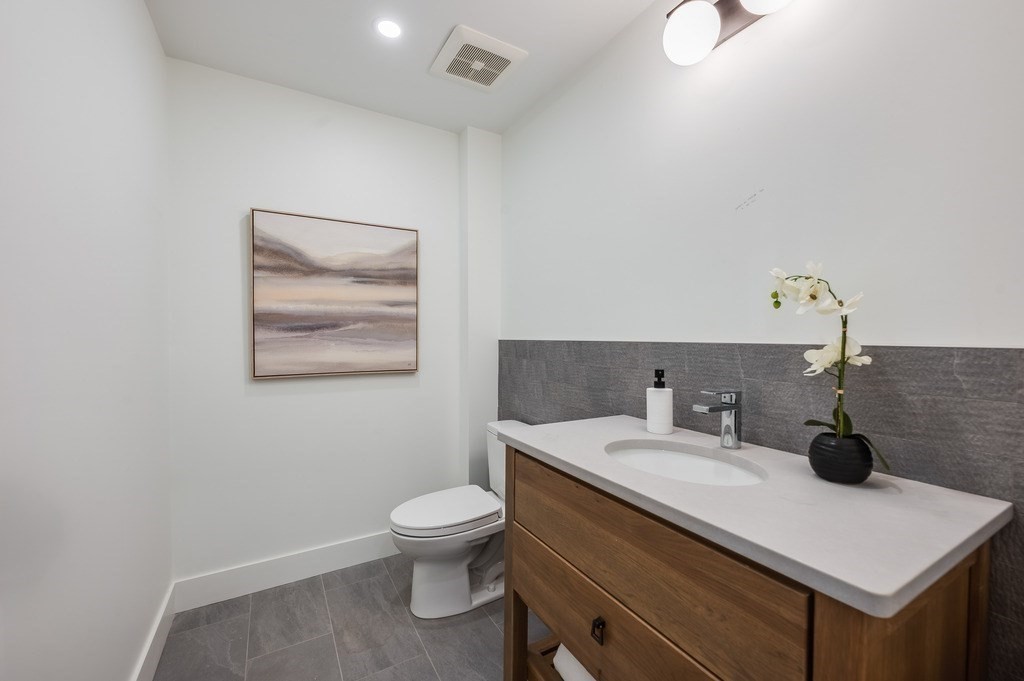 96 Otis Street, Unit 2 Cambridge, MA 02141 - Photo 19 of 42 a bathroom with a sink mirror and toilet