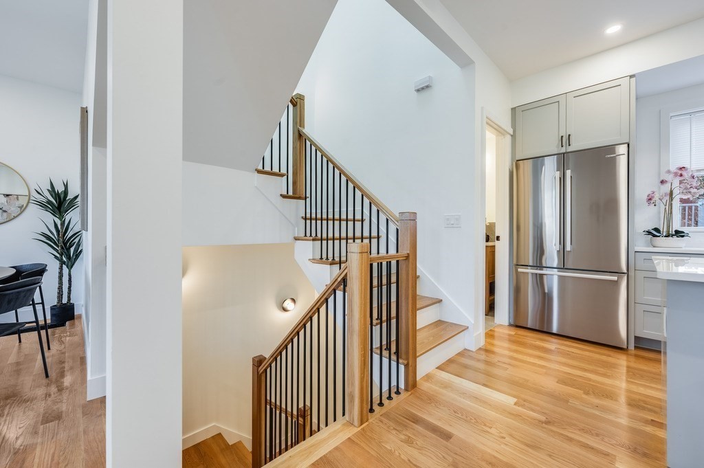 96 Otis Street, Unit 2 Cambridge, MA 02141 - Photo 20 of 42 a view of a hallway with wooden floor and entryway