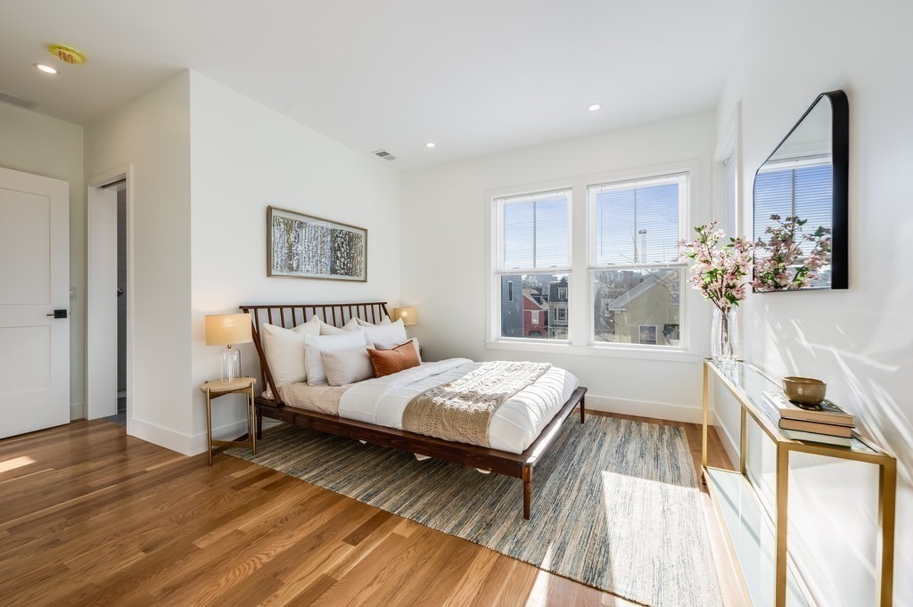 96 Otis Street, Unit 2 Cambridge, MA 02141 - Photo 22 of 42 a bedroom with a bed and wooden floor