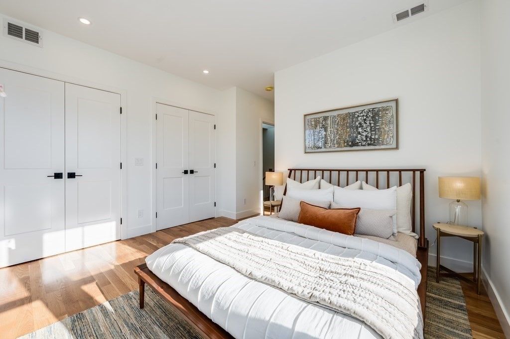 96 Otis Street, Unit 2 Cambridge, MA 02141 - Photo 24 of 42 a bedroom with bed and a night stand