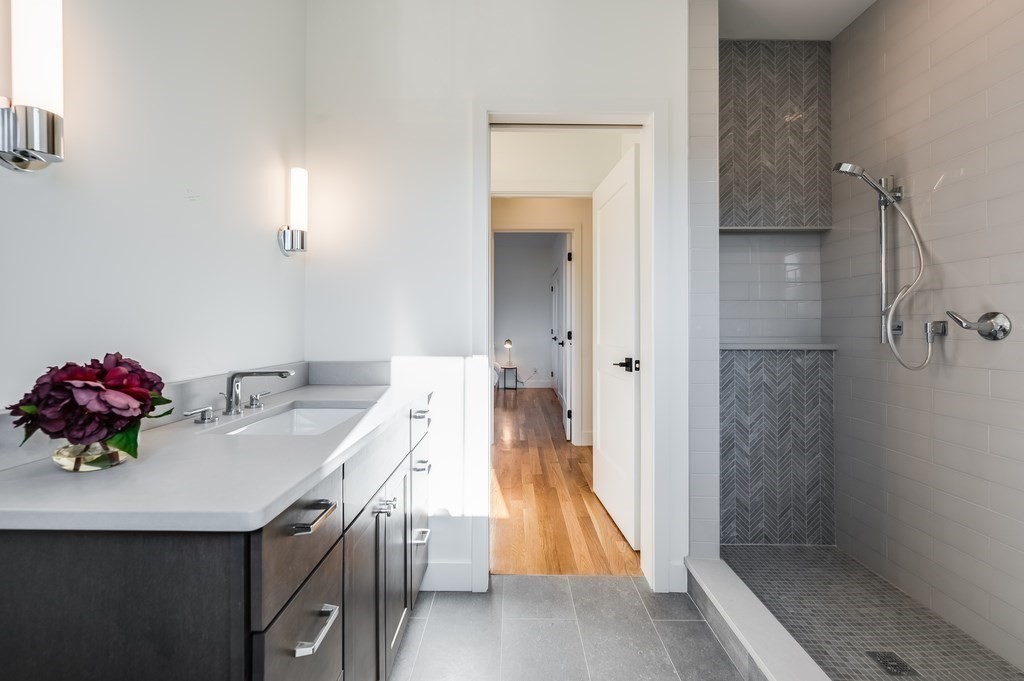 96 Otis Street, Unit 2 Cambridge, MA 02141 - Photo 25 of 42 a bathroom with a sink and mirror