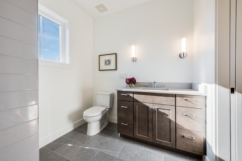 96 Otis Street, Unit 2 Cambridge, MA 02141 - Photo 26 of 42 a bathroom with a toilet sink and mirror
