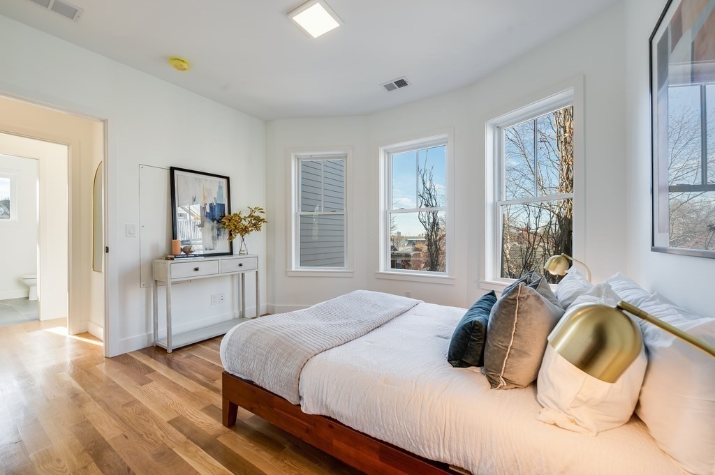 96 Otis Street, Unit 2 Cambridge, MA 02141 - Photo 27 of 42 a bedroom with a bed and a large window