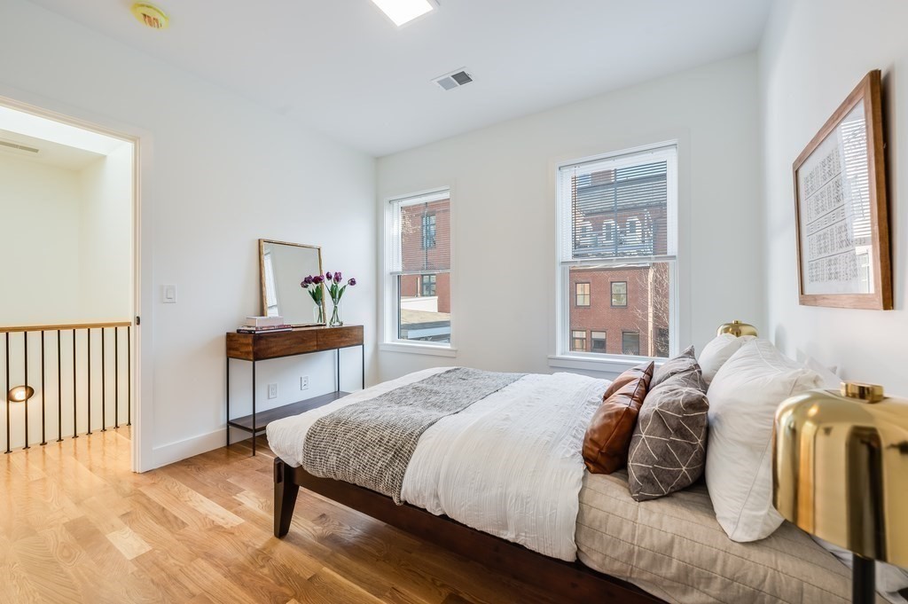 96 Otis Street, Unit 2 Cambridge, MA 02141 - Photo 30 of 42 a bedroom with a bed and a table