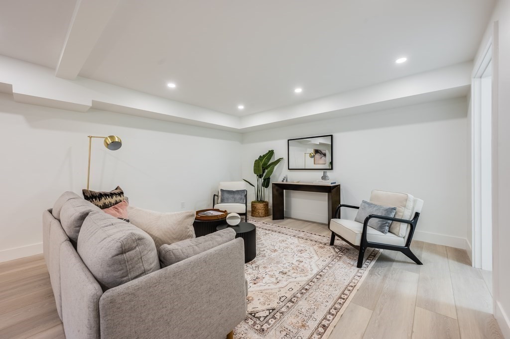96 Otis Street, Unit 2 Cambridge, MA 02141 - Photo 33 of 42 a living room with furniture and wooden floor
