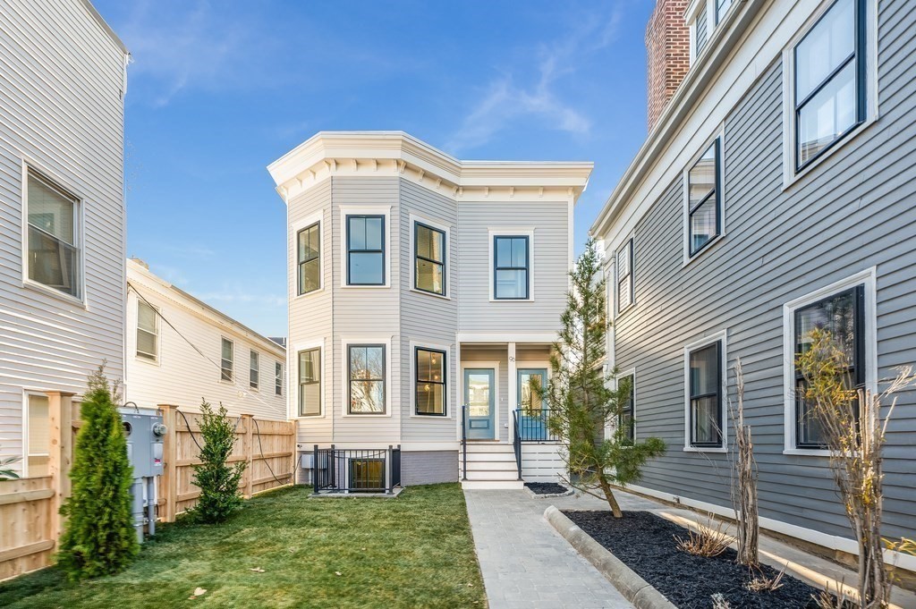 96 Otis Street, Unit 2 Cambridge, MA 02141 - Photo 41 of 42 a front view of a house with a yard