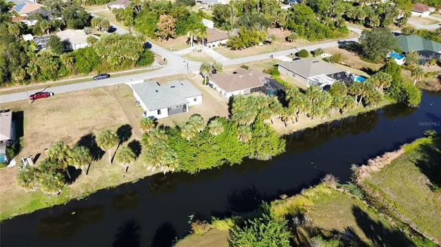 an aerial view of a residential houses with yard