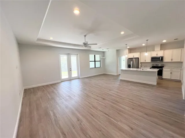 a view of kitchen and hall with wooden floor