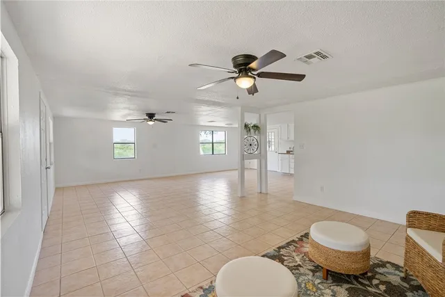 a view of a livingroom with furniture and a ceiling fan