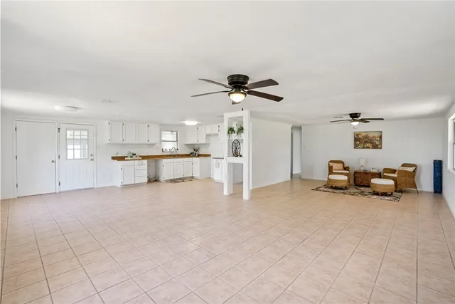 a view of a livingroom with furniture and a chandelier fan