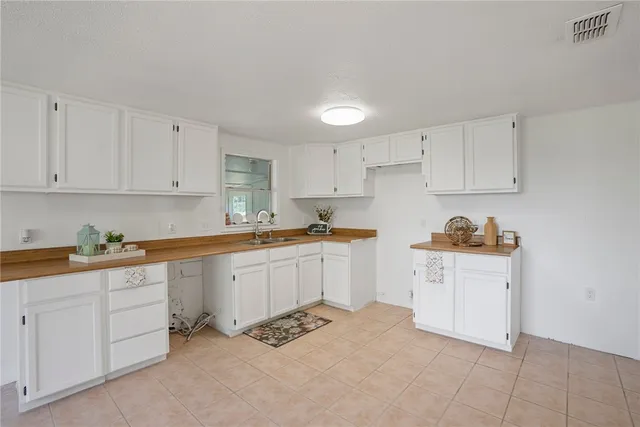 a kitchen with granite countertop white cabinets and white appliances