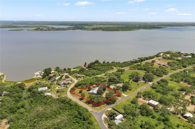 an aerial view of a house with a yard and garden