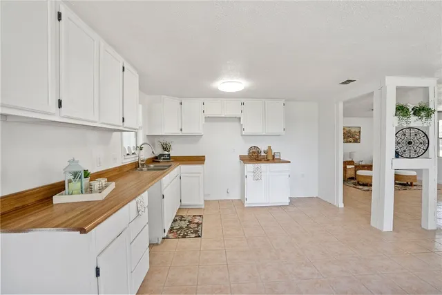 a large white kitchen with cabinets