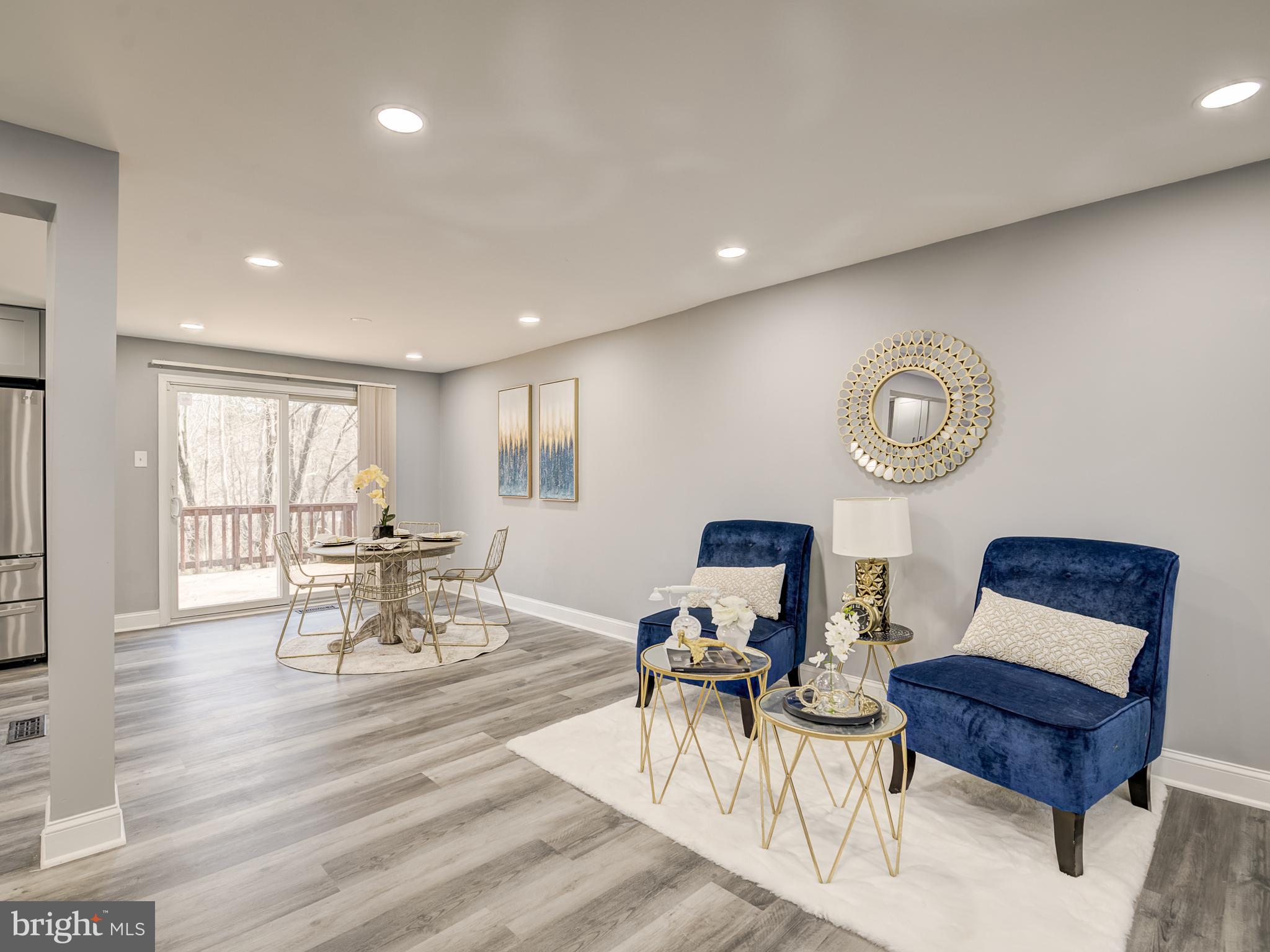 10814 Oldfield Drive Reston, VA 20191 - Photo 13 of 77 a living room with furniture a table and a large window