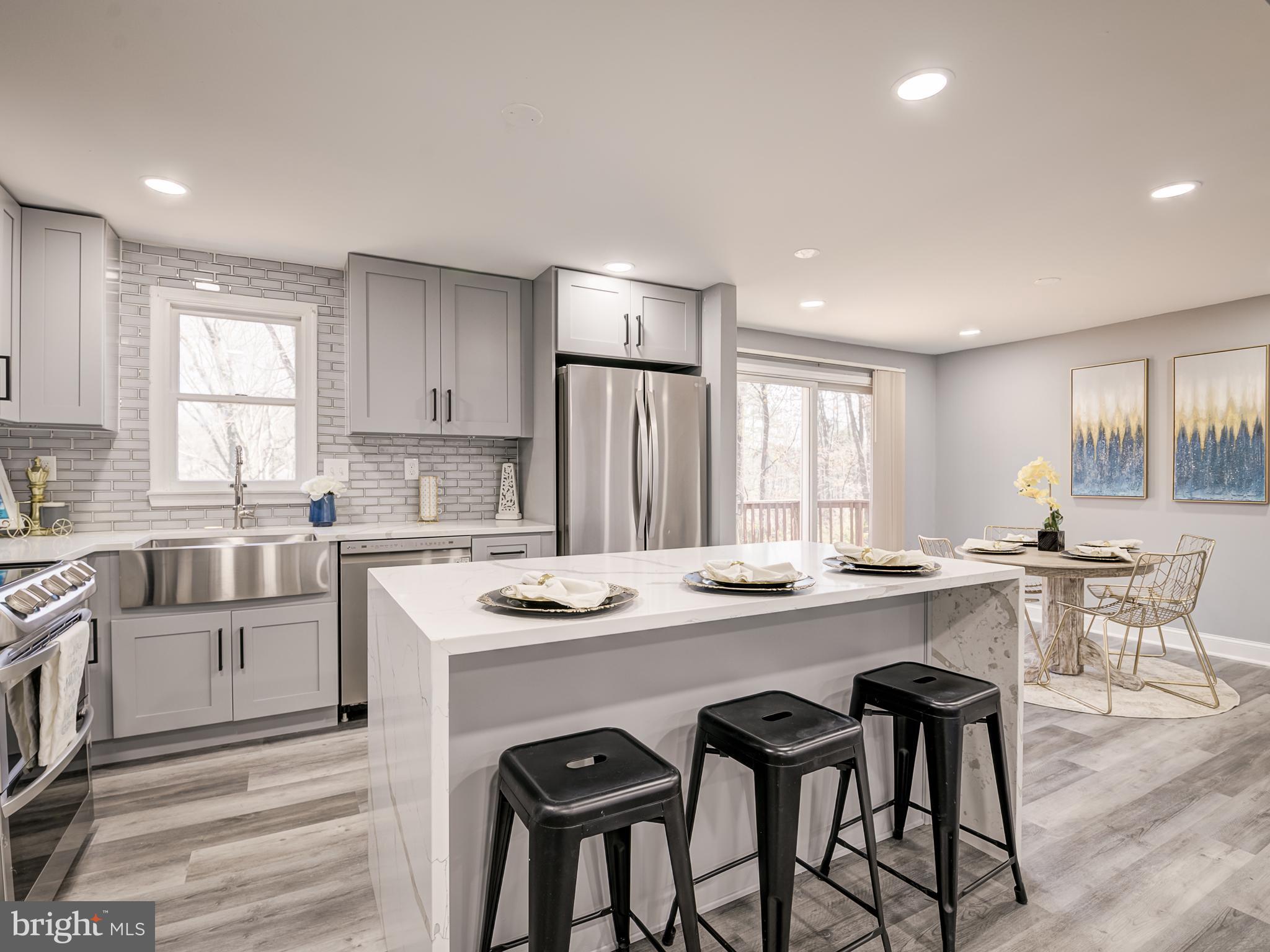 10814 Oldfield Drive Reston, VA 20191 - Photo 24 of 77 a kitchen with a table and chairs in it