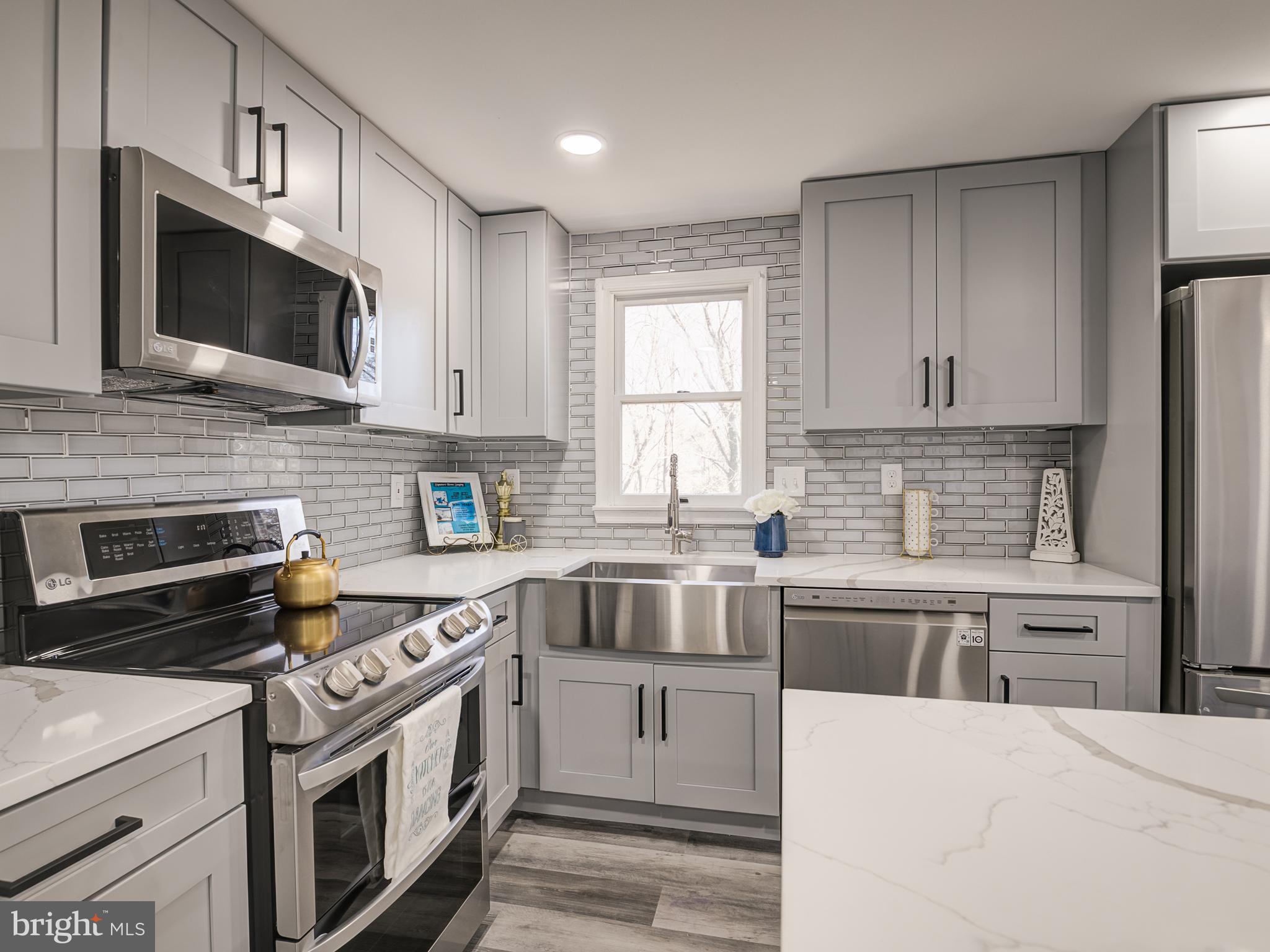 10814 Oldfield Drive Reston, VA 20191 - Photo 25 of 77 a kitchen with stainless steel appliances a stove microwave and sink