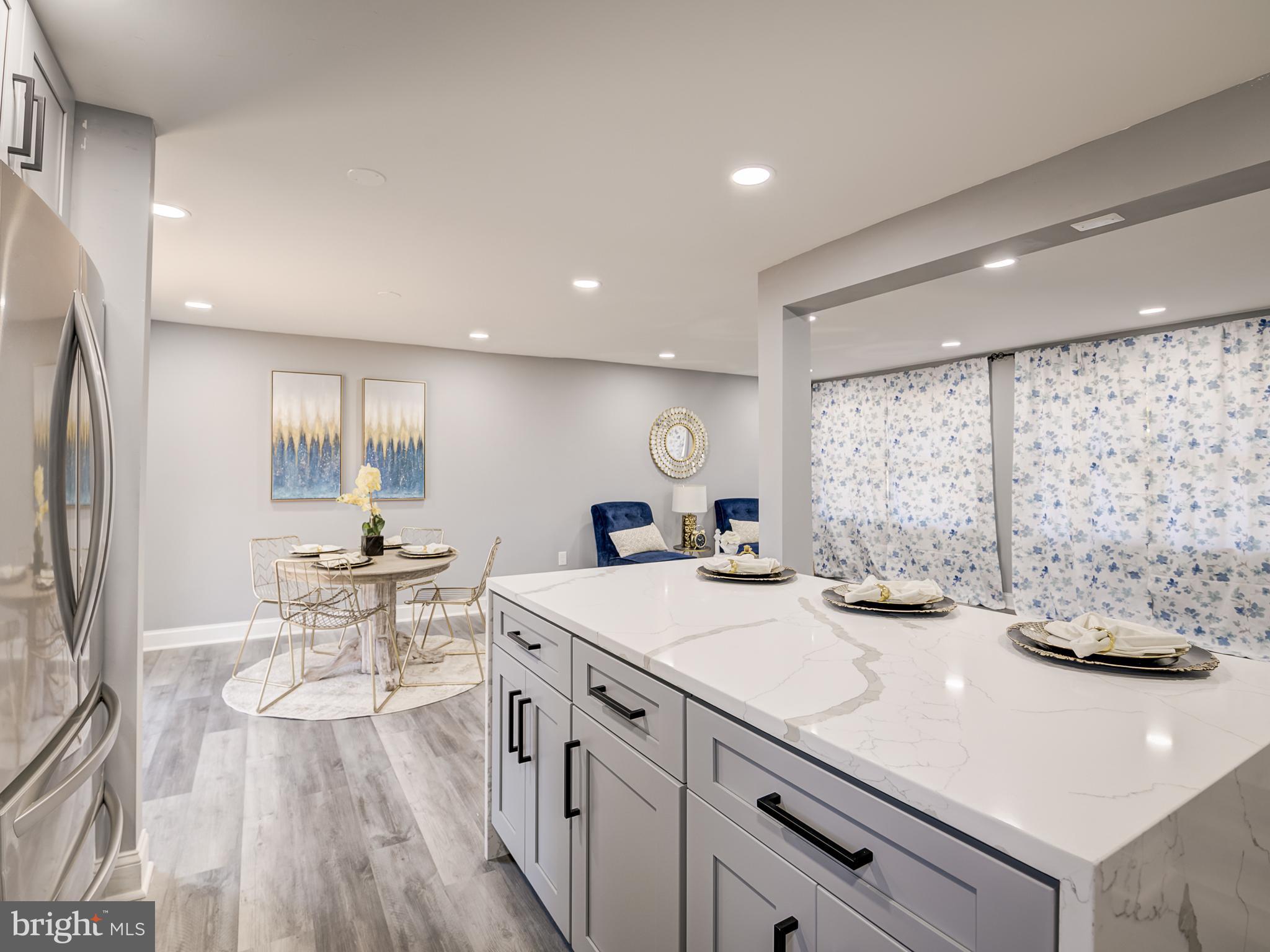 10814 Oldfield Drive Reston, VA 20191 - Photo 26 of 77 a view of a kitchen counter space a sink wooden floor and living room view