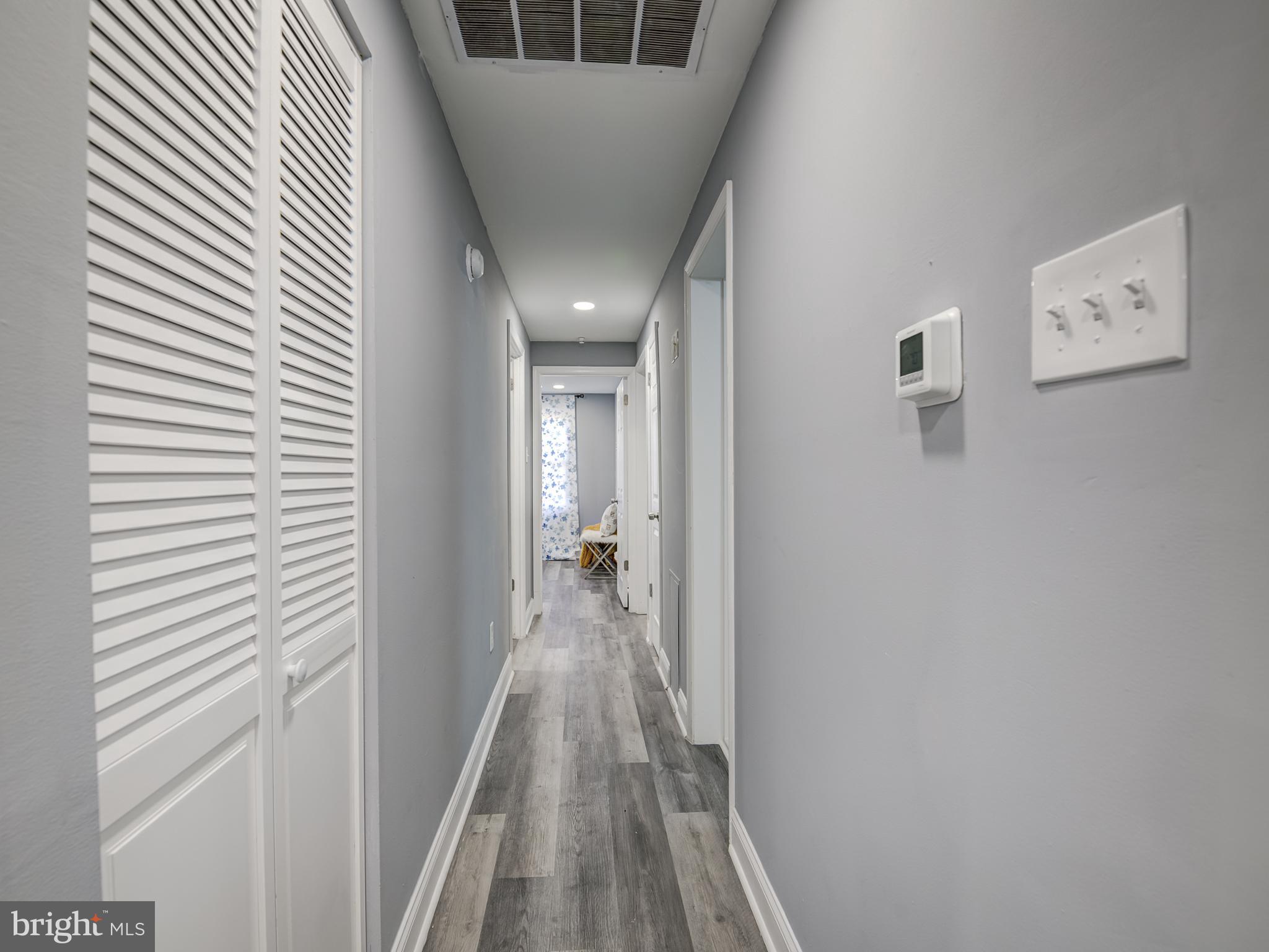 10814 Oldfield Drive Reston, VA 20191 - Photo 27 of 77 a view of a hallway with wooden floor and staircase