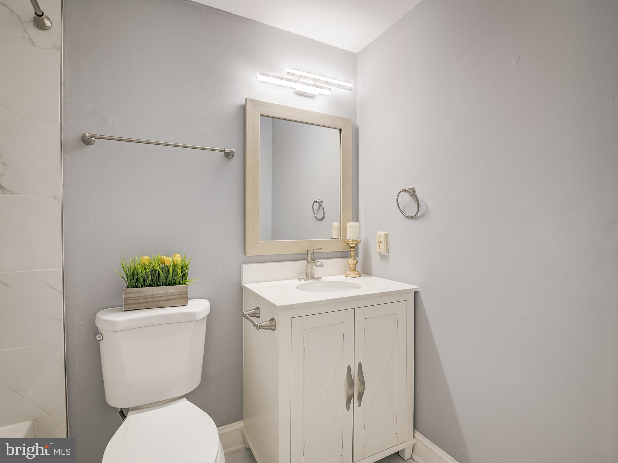 10814 Oldfield Drive Reston, VA 20191 - Photo 28 of 77 a bathroom with a toilet sink and mirror