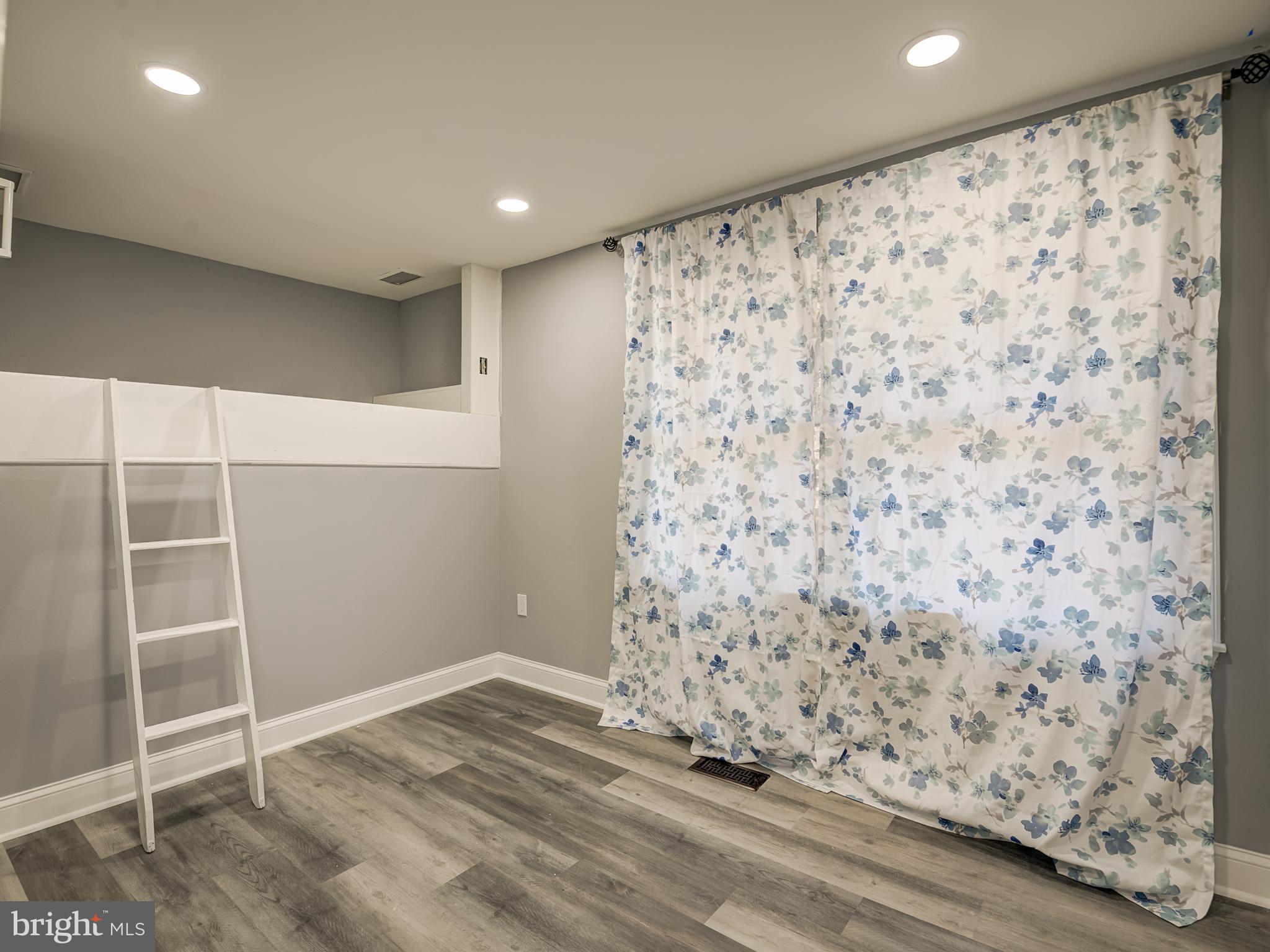 10814 Oldfield Drive Reston, VA 20191 - Photo 31 of 77 a view of a livingroom with wooden floor and a window