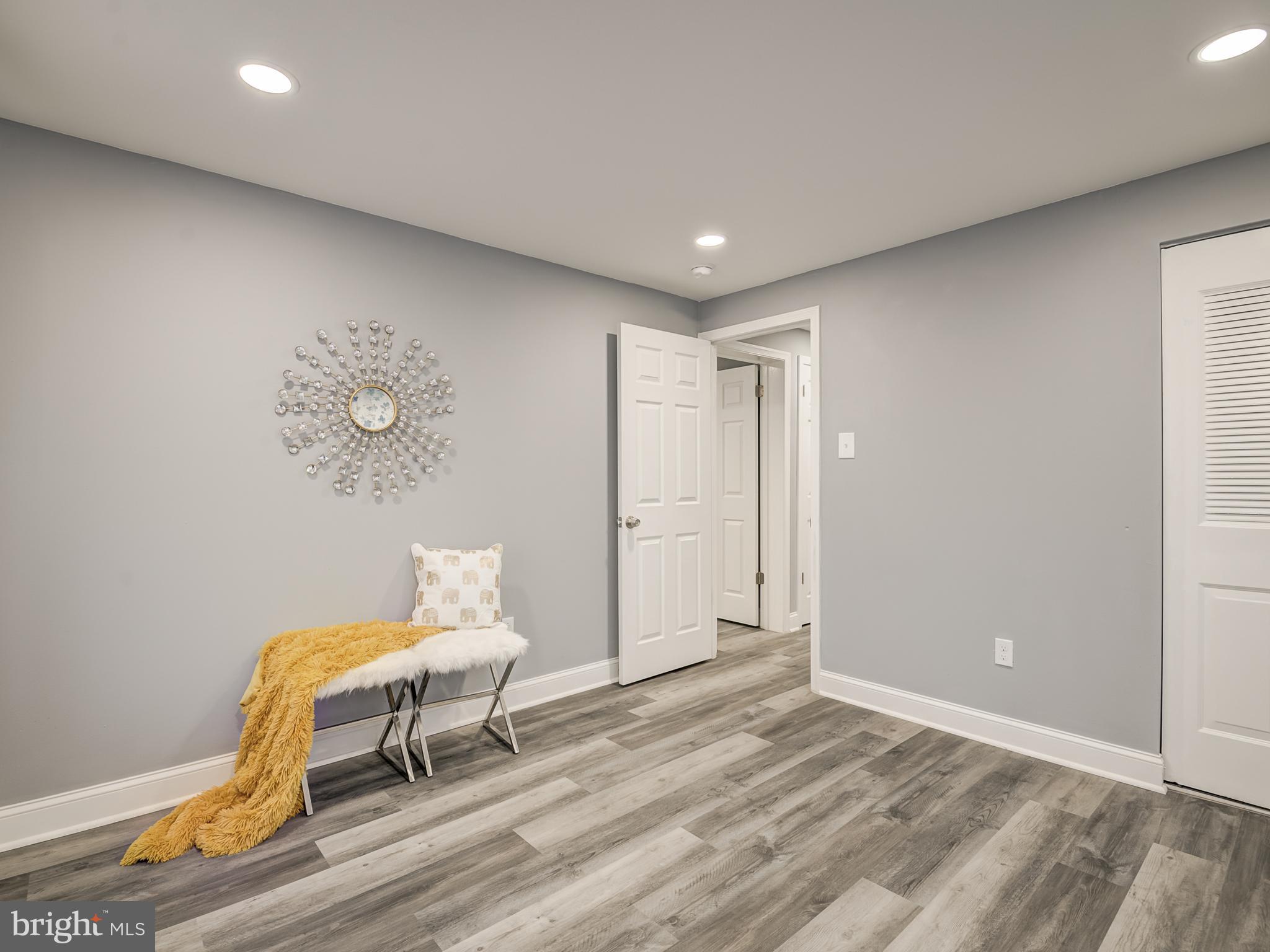 10814 Oldfield Drive Reston, VA 20191 - Photo 36 of 77 a view of a room with wooden floor and lounge chair