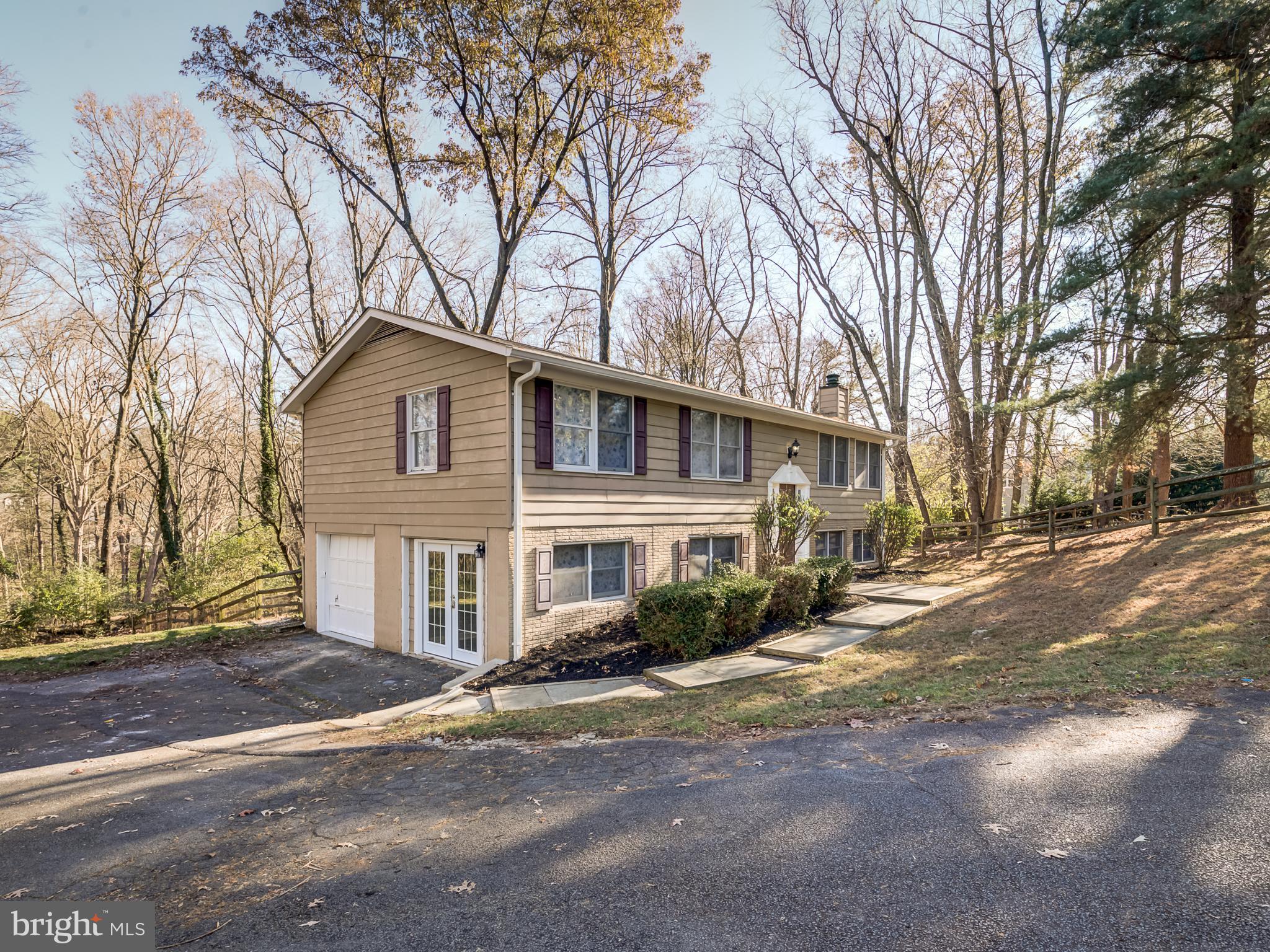 10814 Oldfield Drive Reston, VA 20191 - Photo 5 of 77 a front view of a house with a yard and garage