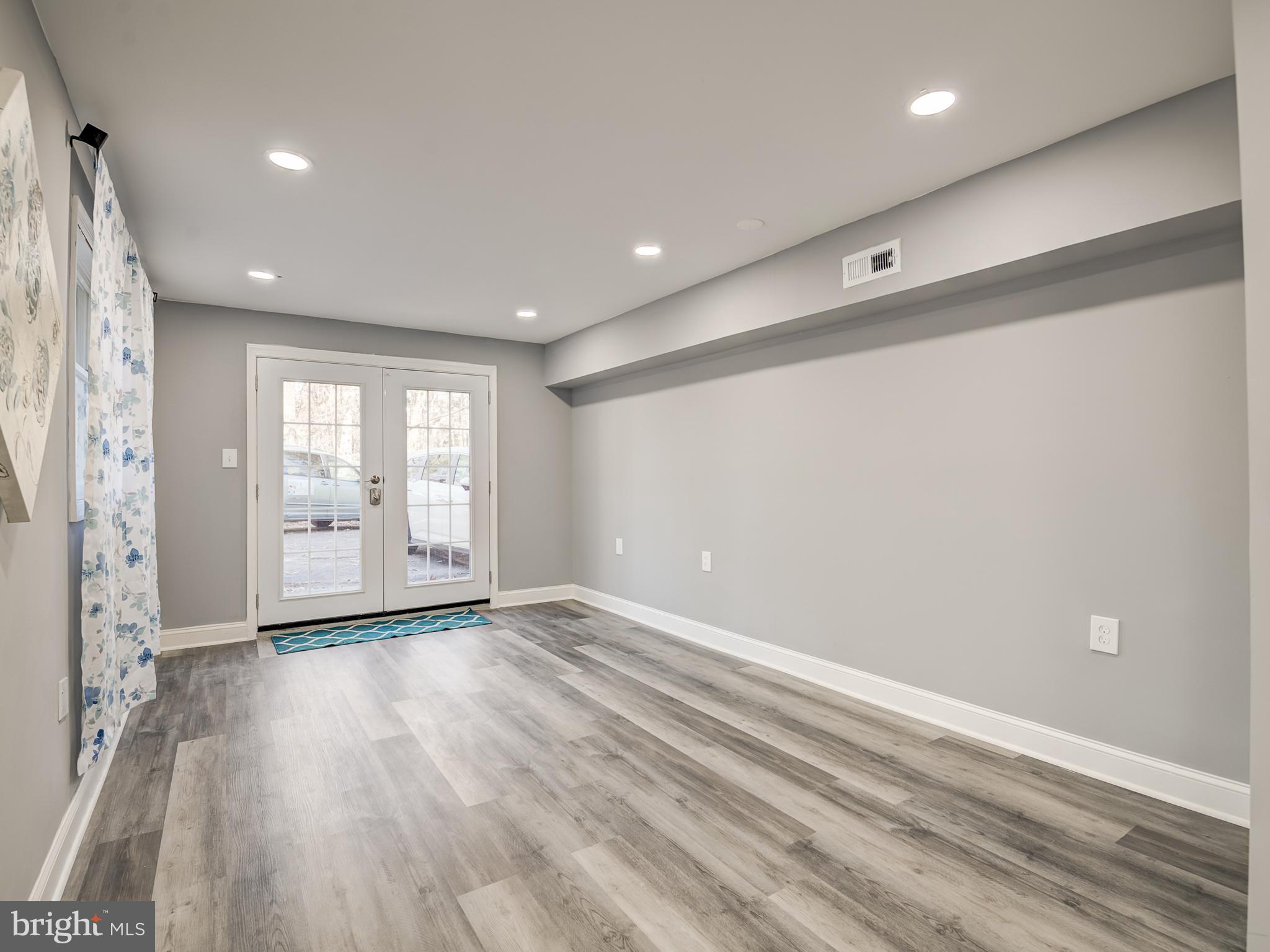 10814 Oldfield Drive Reston, VA 20191 - Photo 59 of 77 a view of an empty room with wooden floor and a window