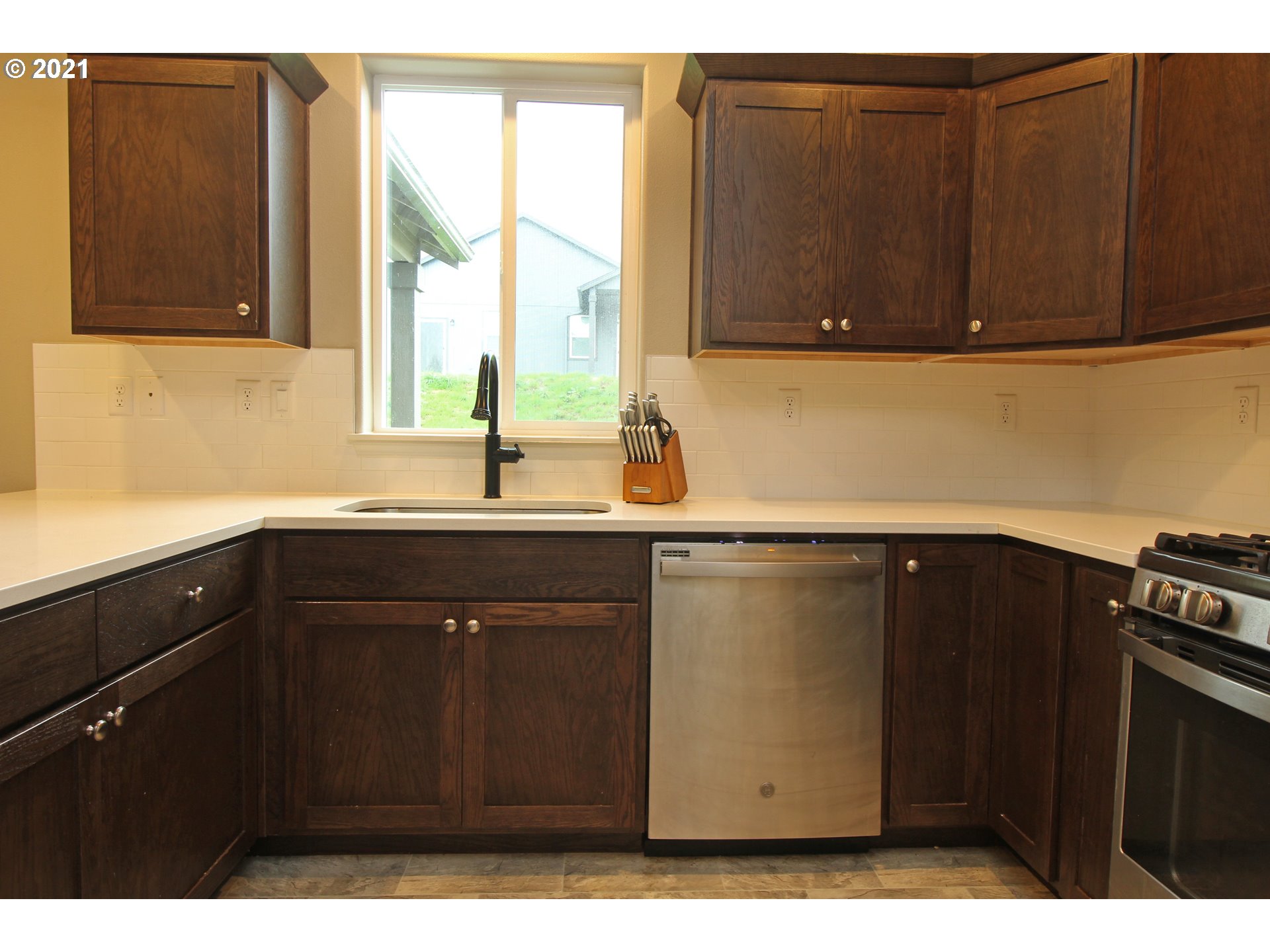 2041 South 59th Street Springfield, OR 97478 - Photo 11 of 31 a kitchen with a sink a window and cabinets