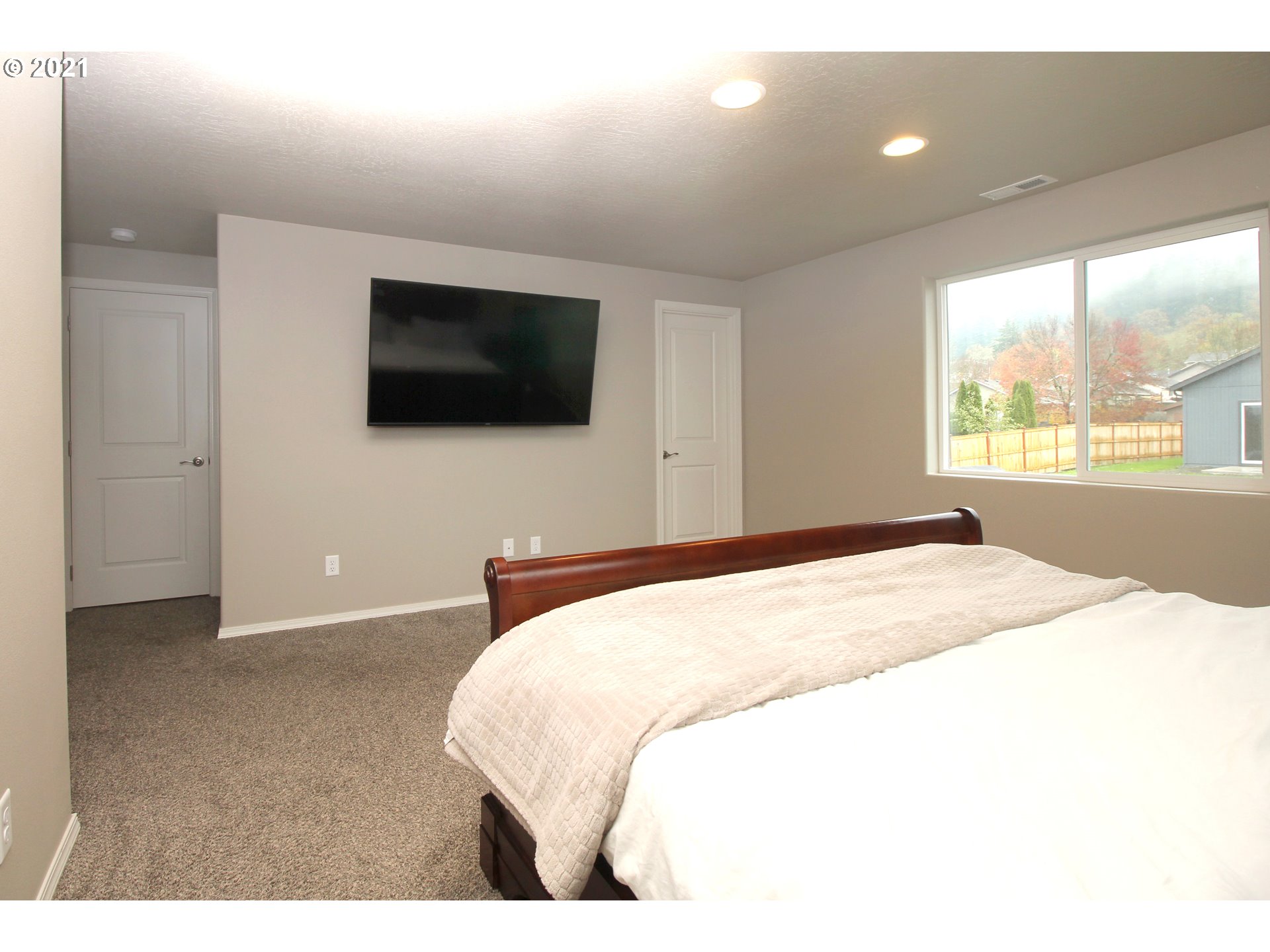 2041 South 59th Street Springfield, OR 97478 - Photo 14 of 31 a bedroom with a bed and a flat screen tv
