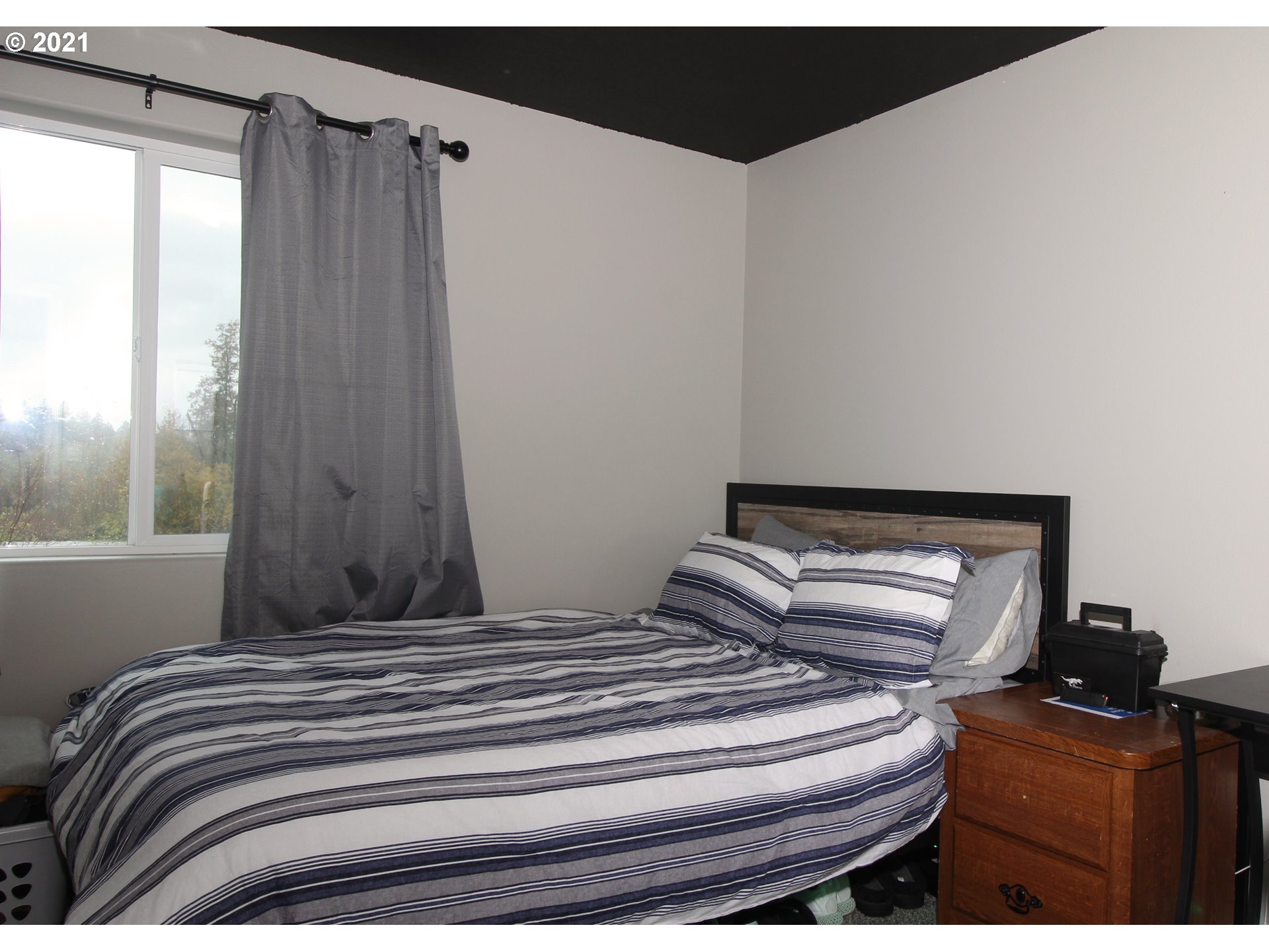 2041 South 59th Street Springfield, OR 97478 - Photo 22 of 31 a bedroom with a bed and wooden floor