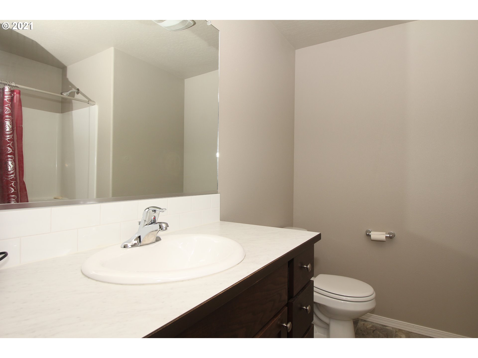 2041 South 59th Street Springfield, OR 97478 - Photo 24 of 31 a bathroom with a sink a toilet and mirror