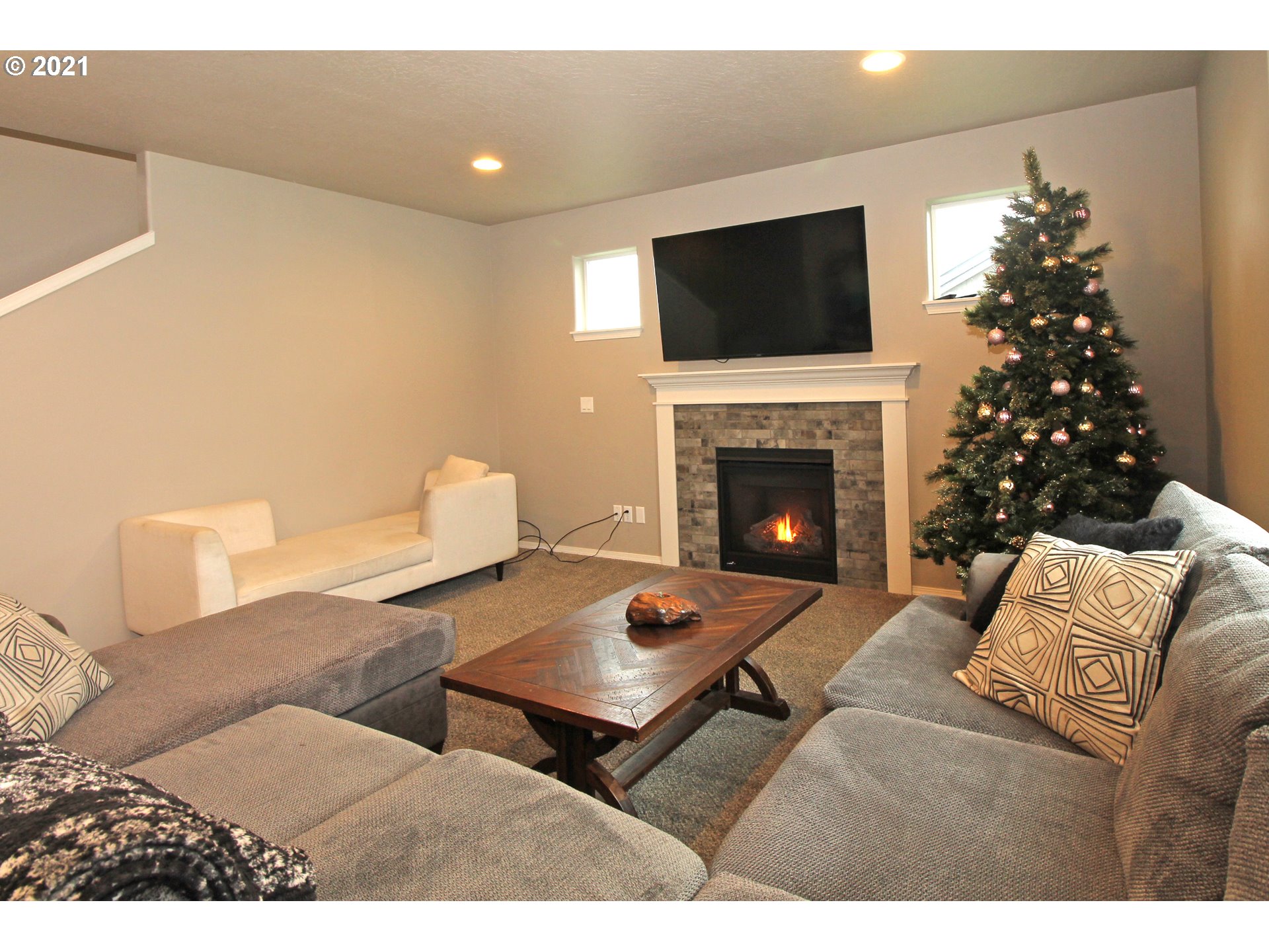 2041 South 59th Street Springfield, OR 97478 - Photo 5 of 31 a living room with furniture a flat screen tv and a fireplace