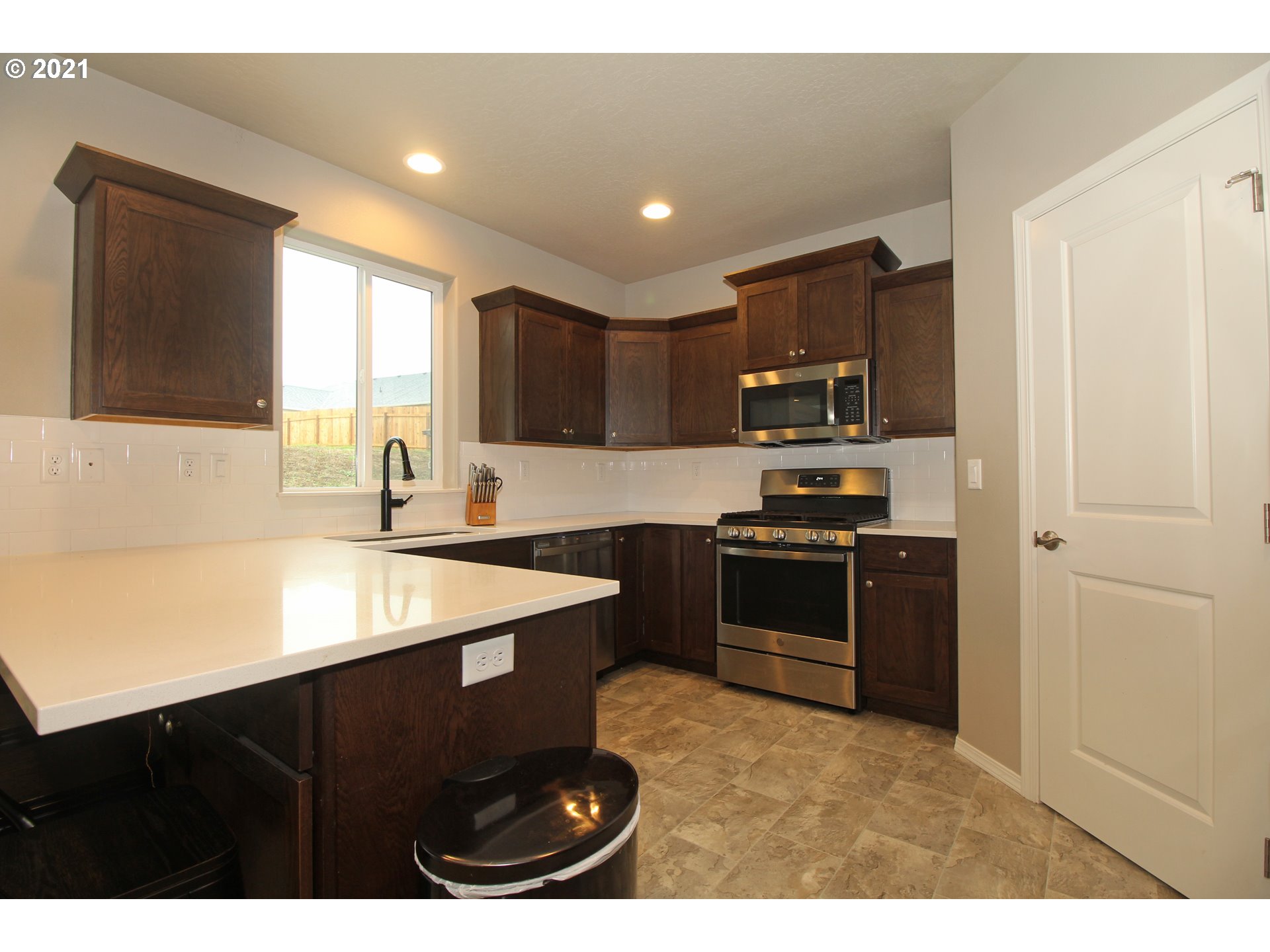 2041 South 59th Street Springfield, OR 97478 - Photo 9 of 31 a kitchen with a sink stove top oven and refrigerator