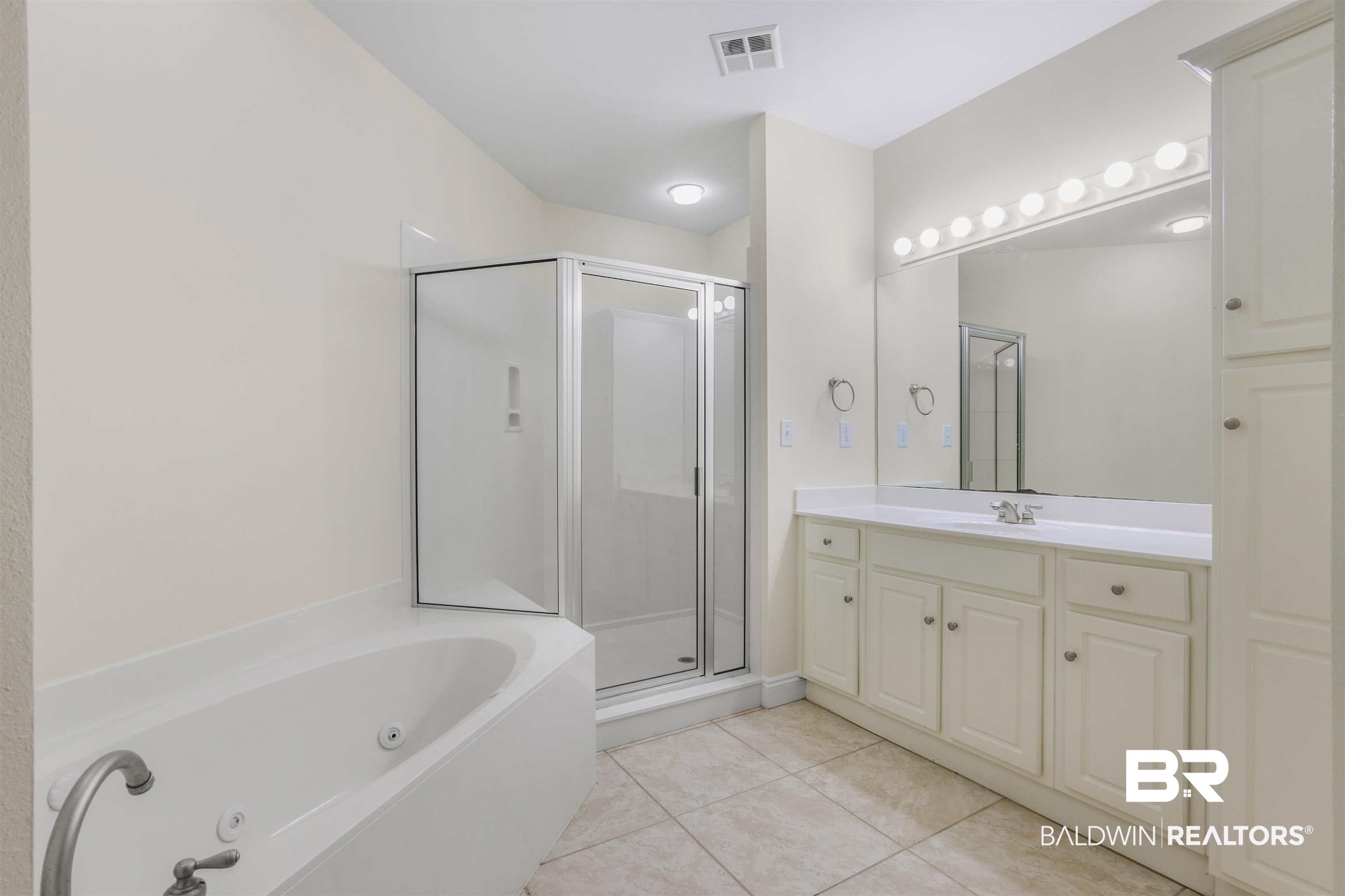 28250 Canal Road, Unit 106 Orange Beach, AL 36561 - Photo 20 of 50 Bathroom with vanity, a whirlpool tub, a shower stall, and light tile patterned flooring