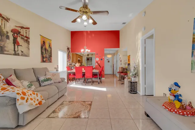a view of a balcony with chairs and a potted plant