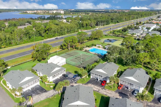 an aerial view of a city with lots of residential buildings and mountain view in back