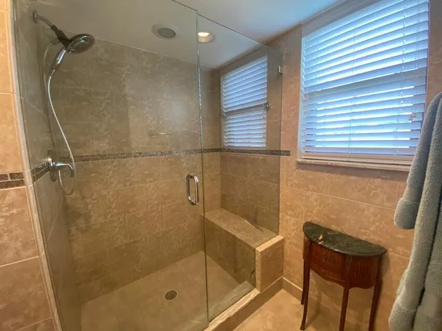 a bathroom with a shower and a sink