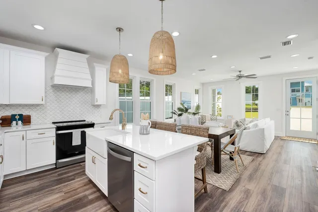 a kitchen with a table chairs stove and cabinets