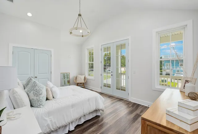 a spacious bedroom with a bed and wooden floor