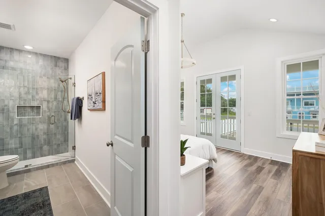 a hallway with sliding door and wooden floor
