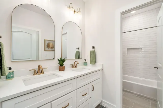 a bathroom with a double vanity sink and a mirror