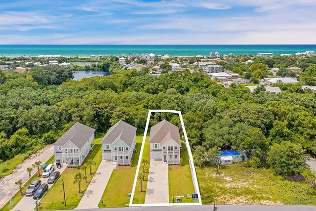 an aerial view of a house with a yard