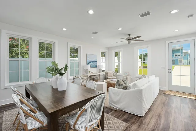 a living room with furniture potted plant and window