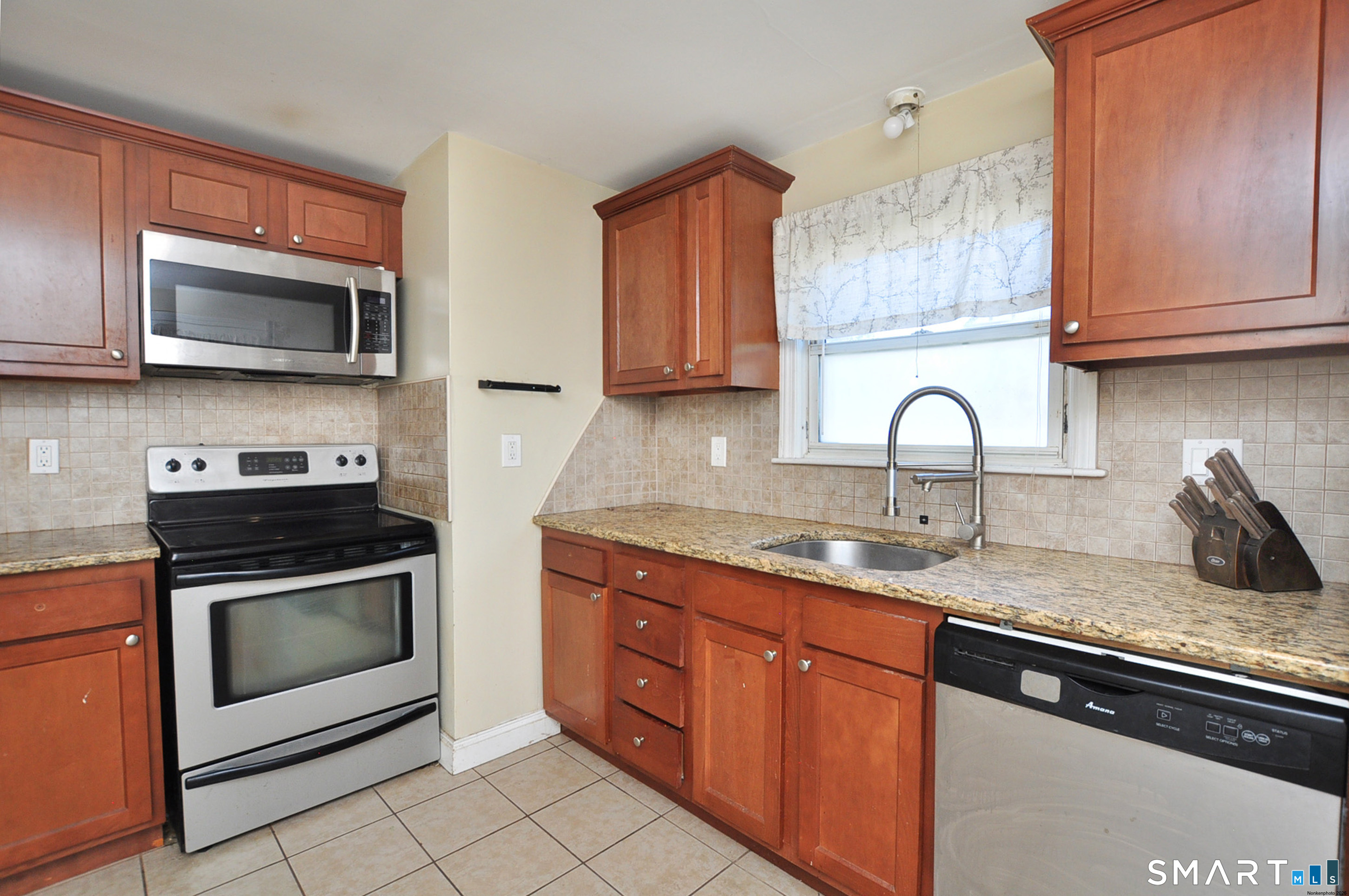 103 West Center Street Manchester, CT 06040 - Photo 14 of 29 a kitchen with stainless steel appliances granite countertop a sink stove and microwave