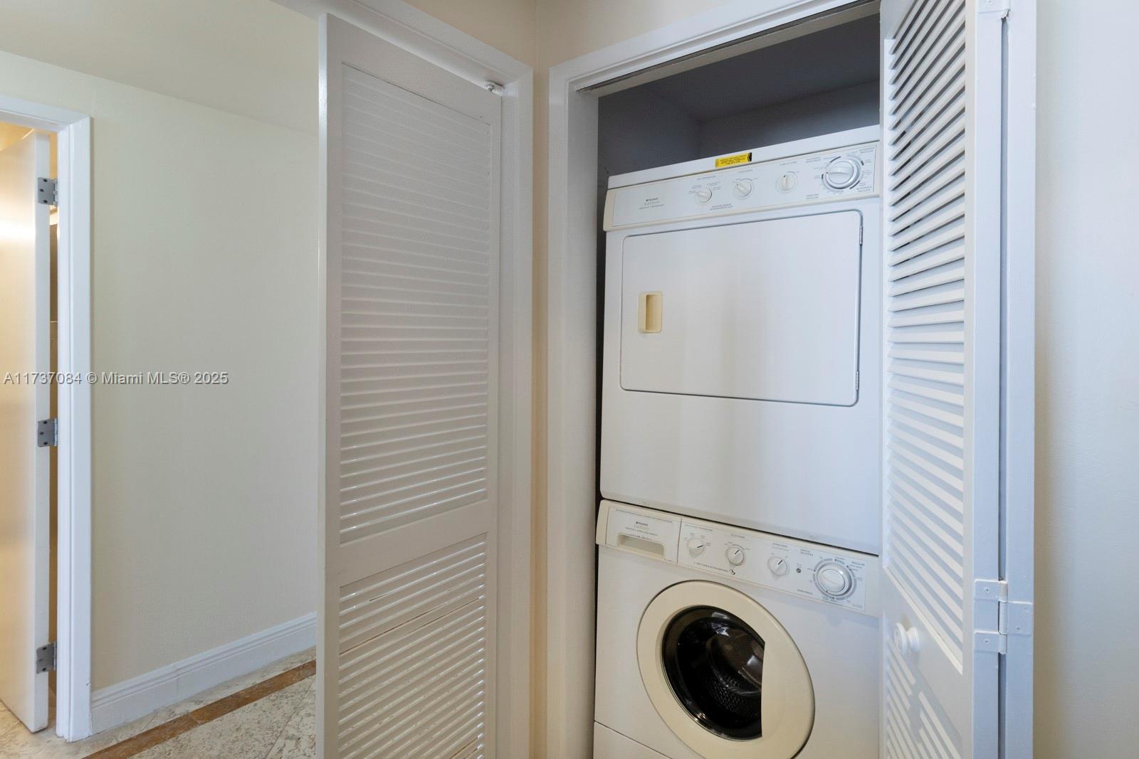 1581 Brickell Avenue, Unit 1408 Miami, FL 33129 - Photo 14 of 25 a utility room with dryer and washer